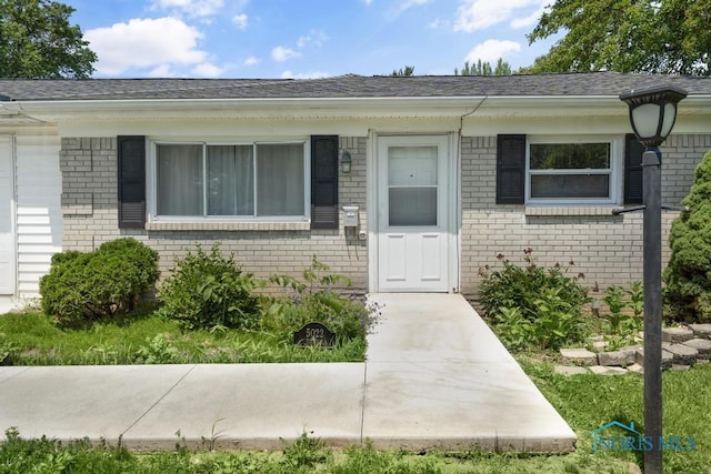 5022 Stengel Ave, Toledo, OH 43614 - property entrance with brick siding and roof with shingles