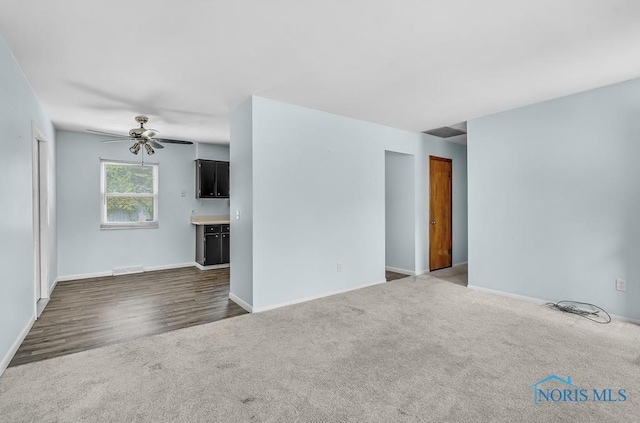 5022 Stengel Ave, Toledo, OH 43614 - unfurnished living room featuring ceiling fan, dark carpet, and dark wood-type flooring