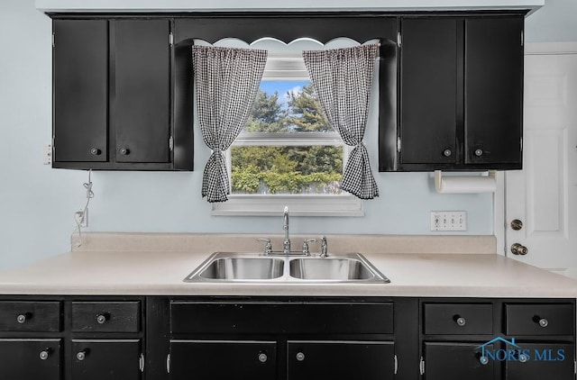 5022 Stengel Ave, Toledo, OH 43614 - kitchen featuring dark cabinetry and light countertops