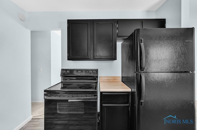 5022 Stengel Ave, Toledo, OH 43614 - kitchen with black appliances, dark cabinets, light countertops, and wood finished floors