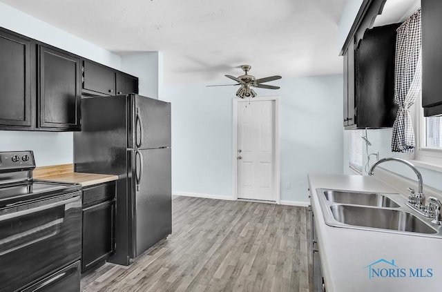 5022 Stengel Ave, Toledo, OH 43614 - kitchen featuring range with electric cooktop, freestanding refrigerator, dark cabinetry, and ceiling fan