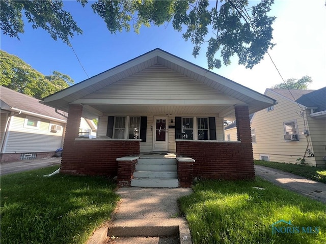1048 Hawk St, Toledo, OH 43612 - bungalow-style home featuring covered porch and brick siding