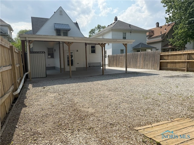 831 Butler St, Toledo, OH 43605 - rear view of house with a patio and a fenced backyard