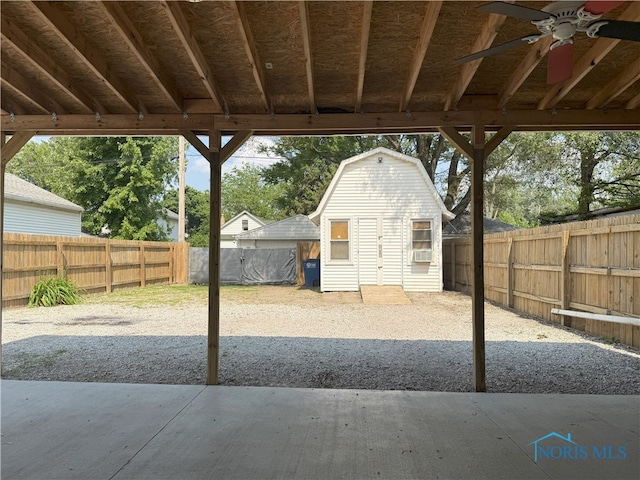 831 Butler St, Toledo, OH 43605 - fenced backyard featuring ceiling fan and a storage shed