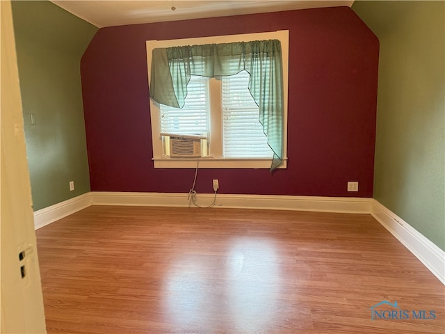 831 Butler St, Toledo, OH 43605 - additional living space with lofted ceiling, wood finished floors, and cooling unit