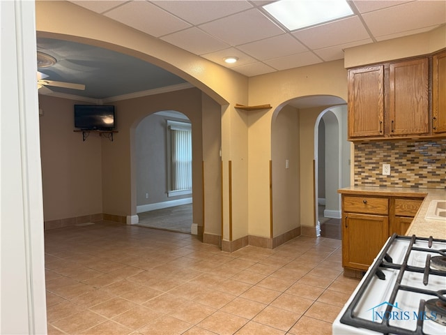831 Butler St, Toledo, OH 43605 - kitchen with arched walkways, brown cabinets, a ceiling fan, light countertops, and stove