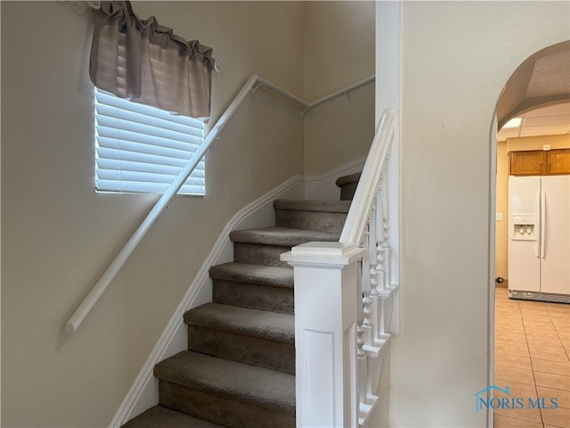 831 Butler St, Toledo, OH 43605 - staircase featuring arched walkways and tile patterned floors