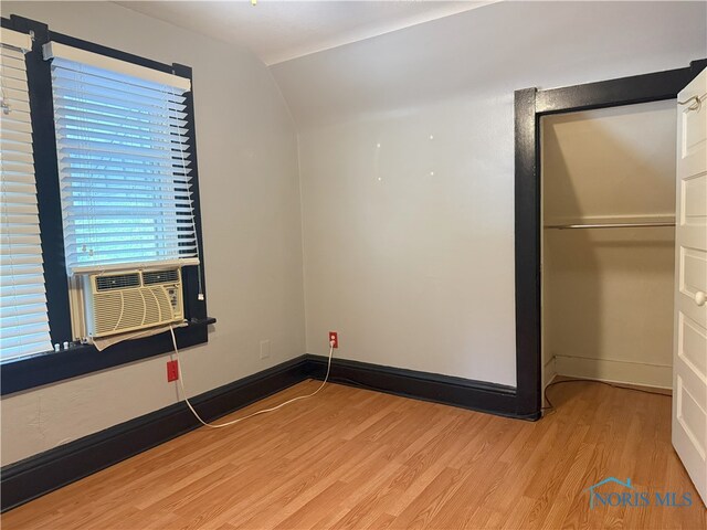 831 Butler St, Toledo, OH 43605 - unfurnished bedroom featuring light wood-style flooring, cooling unit, and lofted ceiling