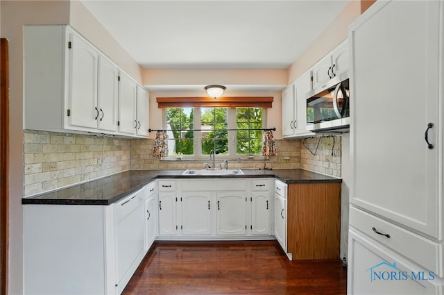 2816 Middlesex Dr, Toledo, OH 43606 - kitchen featuring stainless steel microwave, dark countertops, white cabinets, and dark wood-style flooring
