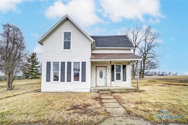 225 2nd St, Latty, OH 45855 - traditional home with a porch, a front yard, and a shingled roof