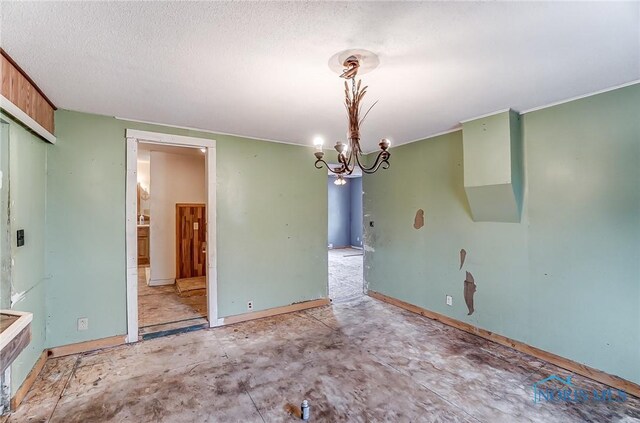 225 2nd St, Latty, OH 45855 - empty room featuring a chandelier and a textured ceiling