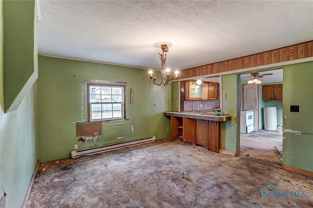 225 2nd St, Latty, OH 45855 - kitchen featuring baseboard heating, a textured ceiling, a chandelier, brown cabinetry, and pendant lighting