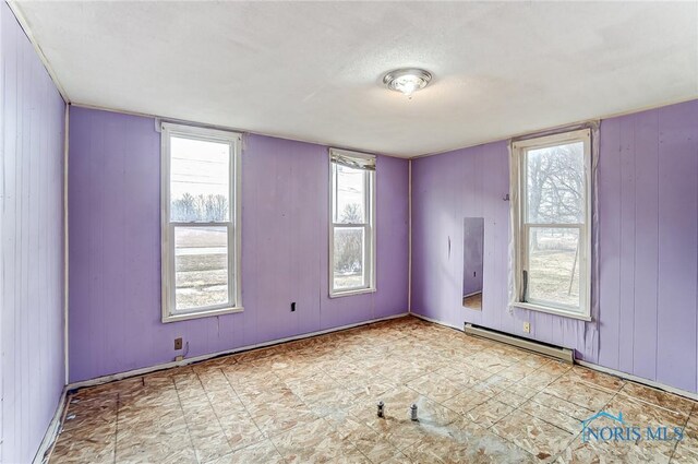 225 2nd St, Latty, OH 45855 - spare room featuring a baseboard radiator and plenty of natural light