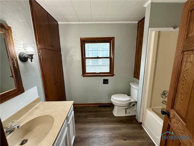 223 E Leggett St, Wauseon, OH 43567 - full bathroom with vanity, wood finished floors, crown molding, and bathtub / shower combination