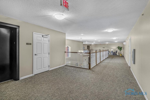 3040 Byrnwyck Unit 201, Maumee, OH 43537 - hall featuring carpet floors, a textured ceiling, and a chandelier