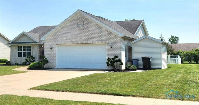 149 Carlee Ln, Findlay, OH 45840 - single story home featuring a garage, brick siding, concrete driveway, a front lawn, and roof with shingles