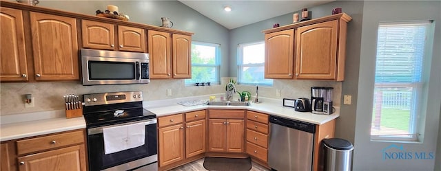 149 Carlee Ln, Findlay, OH 45840 - kitchen with appliances with stainless steel finishes, vaulted ceiling, tasteful backsplash, and light countertops