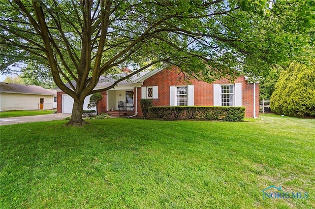 1110 Bourgogne Ave, Bowling Green, OH 43402 - view of front of house featuring concrete driveway, a front yard, and brick siding