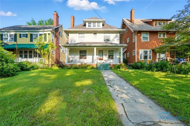 2727 Robinwood Ave, Toledo, OH 43610 - traditional style home featuring a porch, a front yard, and a chimney