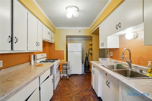 2727 Robinwood Ave, Toledo, OH 43610 - kitchen featuring white appliances, crown molding, white cabinetry, backsplash, and light countertops