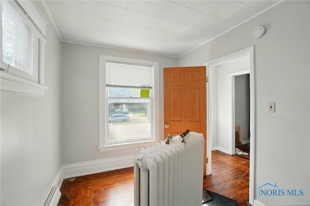 2727 Robinwood Ave, Toledo, OH 43610 - hallway with radiator, healthy amount of natural light, crown molding, and dark wood-style flooring