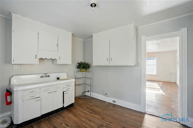 2727 Robinwood Ave, Toledo, OH 43610 - kitchen featuring dark wood-style floors, white cabinets, and light countertops