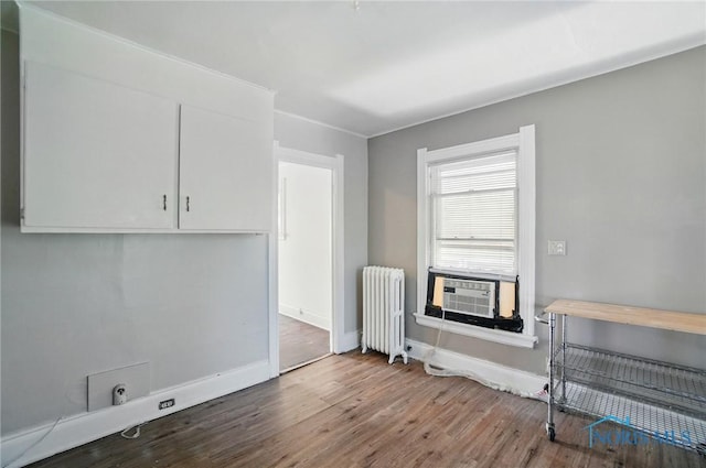 2727 Robinwood Ave, Toledo, OH 43610 - unfurnished dining area featuring radiator, wood finished floors, and cooling unit