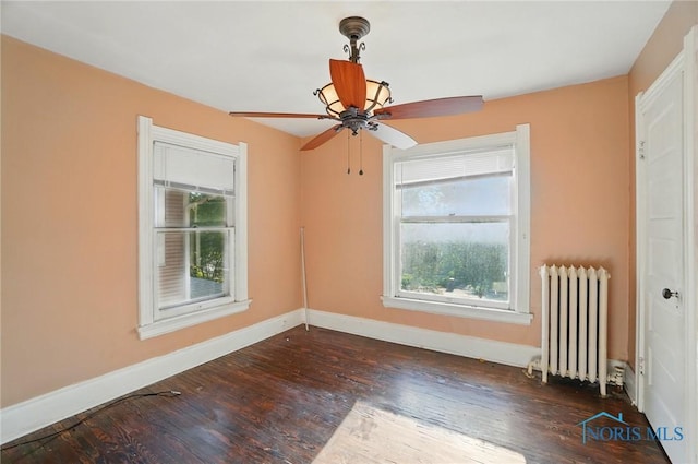 2727 Robinwood Ave, Toledo, OH 43610 - empty room featuring radiator heating unit, wood finished floors, and a ceiling fan