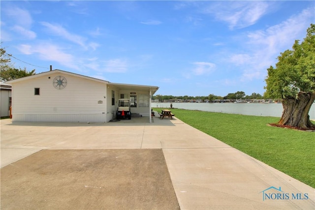 1660 N Compass Ave, Port Clinton, OH 43452 - view of property exterior with a yard and a water view