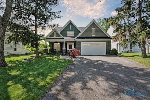440 W 3rd St, Perrysburg, OH 43551 - craftsman-style house with a porch, asphalt driveway, a front yard, and a garage