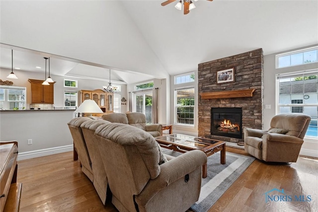 440 W 3rd St, Perrysburg, OH 43551 - living room featuring light wood-style flooring, a fireplace, ceiling fan, high vaulted ceiling, and a chandelier