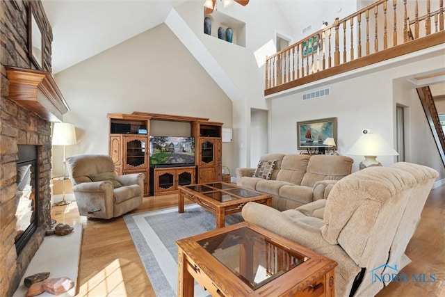 440 W 3rd St, Perrysburg, OH 43551 - living room featuring a fireplace, a towering ceiling, wood finished floors, and ceiling fan