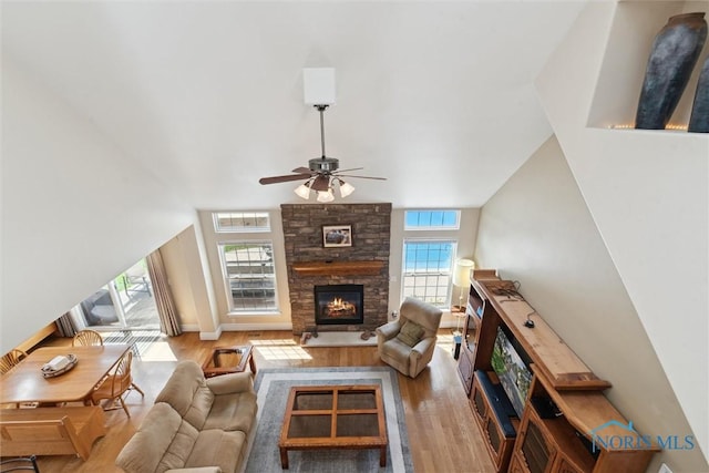 440 W 3rd St, Perrysburg, OH 43551 - living room featuring wood finished floors, a ceiling fan, and a stone fireplace