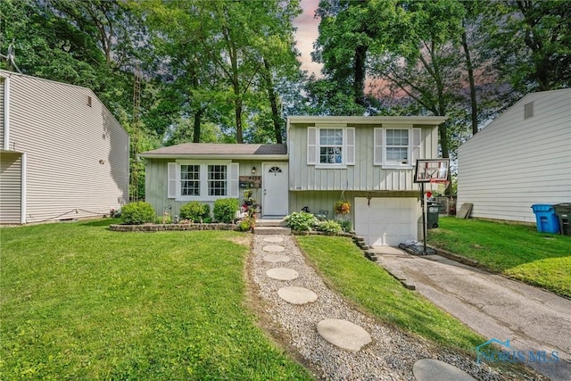 4252 Foxchapel Rd, Toledo, OH 43607 - split level home with board and batten siding, driveway, a garage, and a front lawn
