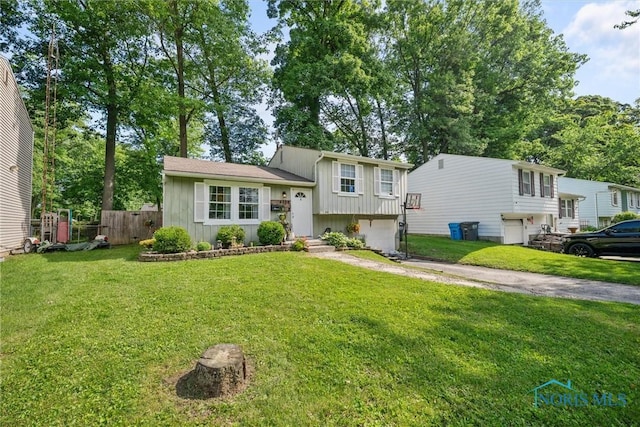 4252 Foxchapel Rd, Toledo, OH 43607 - tri-level home featuring a garage, board and batten siding, and asphalt driveway