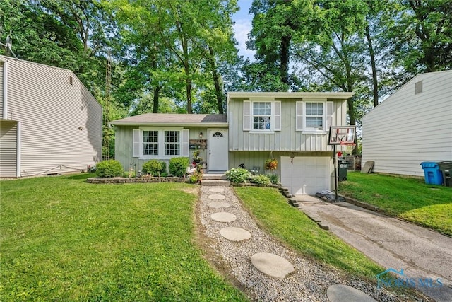 4252 Foxchapel Rd, Toledo, OH 43607 - split level home featuring board and batten siding, driveway, an attached garage, and a front lawn