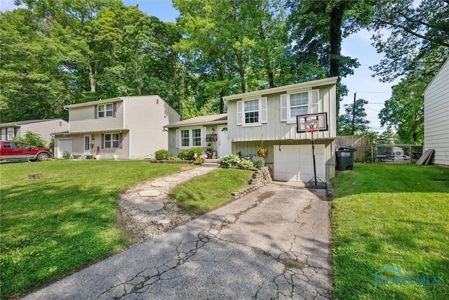 4252 Foxchapel Rd, Toledo, OH 43607 - split level home with driveway, an attached garage, and board and batten siding