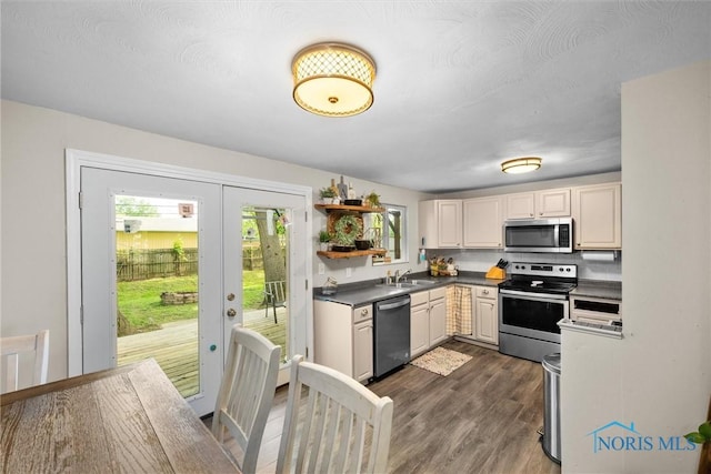 4252 Foxchapel Rd, Toledo, OH 43607 - kitchen featuring stainless steel appliances, open shelves, dark wood-type flooring, dark countertops, and french doors