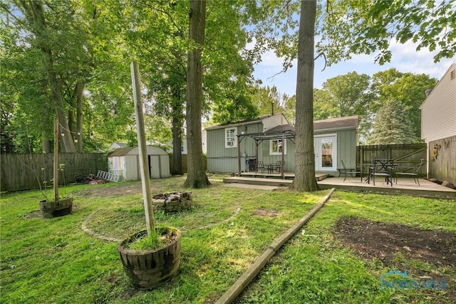 4252 Foxchapel Rd, Toledo, OH 43607 - rear view of house featuring a deck, a storage unit, and a fenced backyard
