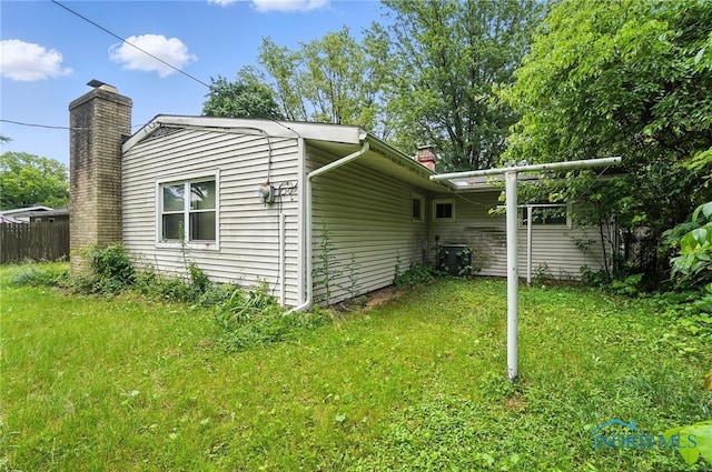3636 Prairie Ave, Toledo, OH 43614 - view of home's exterior with a chimney and a cooling unit
