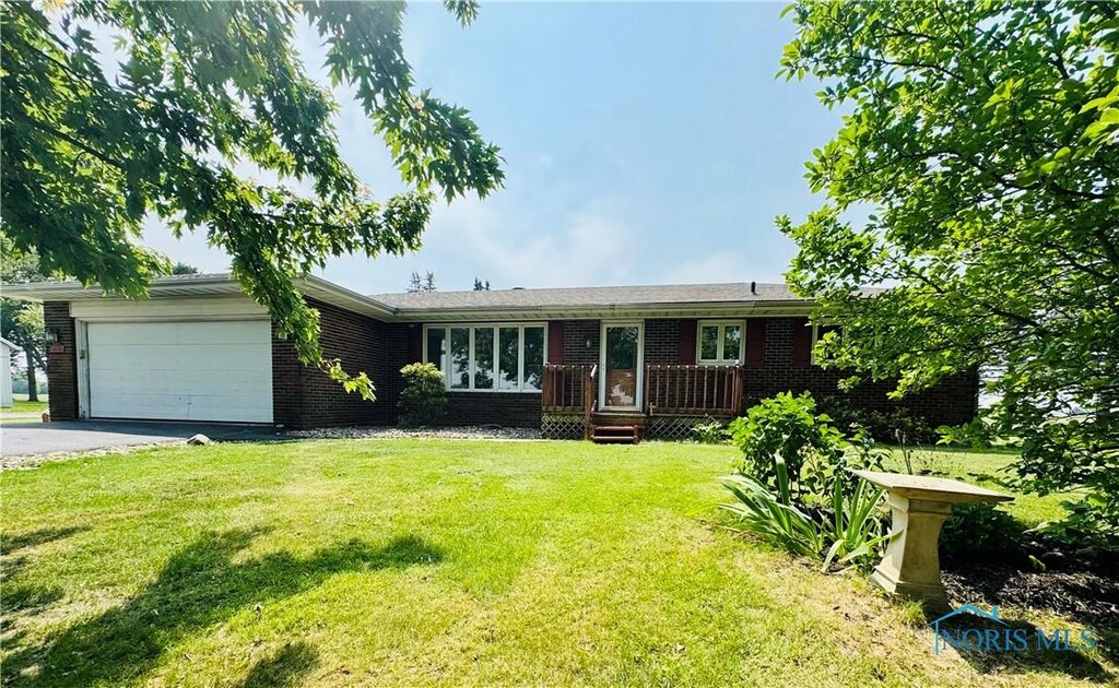 17715 Mitchell Rd, Bowling Green, OH 43402 - ranch-style house featuring brick siding, a garage, driveway, and a front lawn