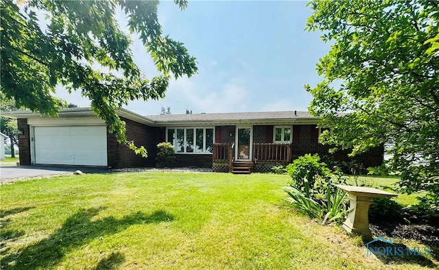 17715 Mitchell Rd, Bowling Green, OH 43402 - ranch-style house featuring brick siding, a garage, driveway, and a front lawn