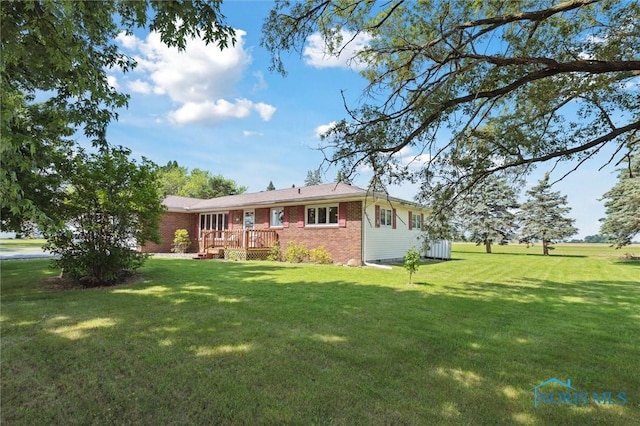 17715 Mitchell Rd, Bowling Green, OH 43402 - rear view of house featuring brick siding, a yard, and a deck