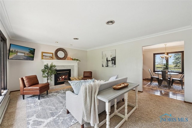 17715 Mitchell Rd, Bowling Green, OH 43402 - living room featuring ornamental molding, a glass covered fireplace, a chandelier, and light carpet