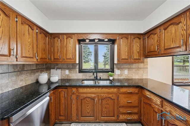 17715 Mitchell Rd, Bowling Green, OH 43402 - kitchen with stainless steel dishwasher, brown cabinetry, and dark stone counters