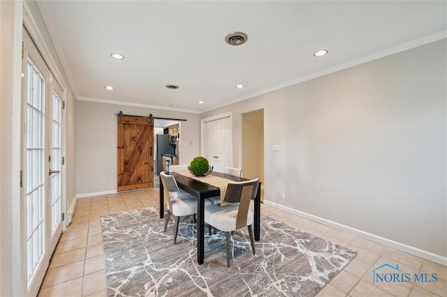 17715 Mitchell Rd, Bowling Green, OH 43402 - dining space featuring a barn door, light tile patterned floors, recessed lighting, and crown molding