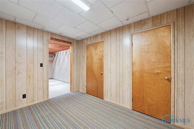17715 Mitchell Rd, Bowling Green, OH 43402 - carpeted empty room featuring wood walls and a drop ceiling