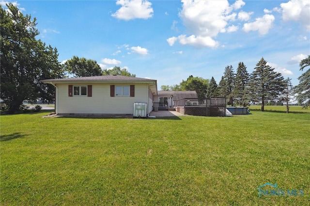 17715 Mitchell Rd, Bowling Green, OH 43402 - back of property with a wooden deck, a lawn, and crawl space