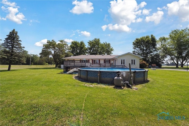 17715 Mitchell Rd, Bowling Green, OH 43402 - rear view of property featuring a lawn, an outdoor pool, and a wooden deck