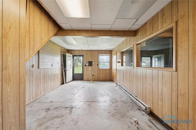 17715 Mitchell Rd, Bowling Green, OH 43402 - unfurnished room featuring a baseboard radiator, wood walls, and unfinished concrete floors